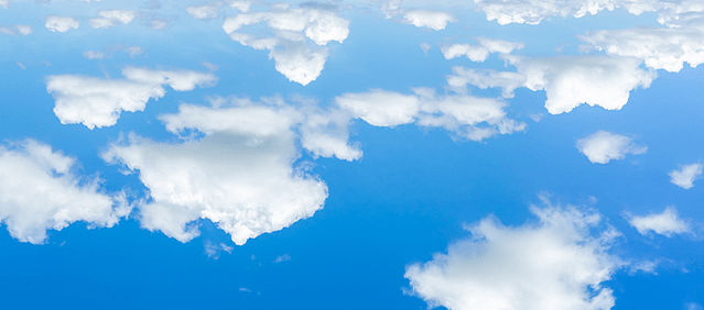 Scattered clouds against a blue sky