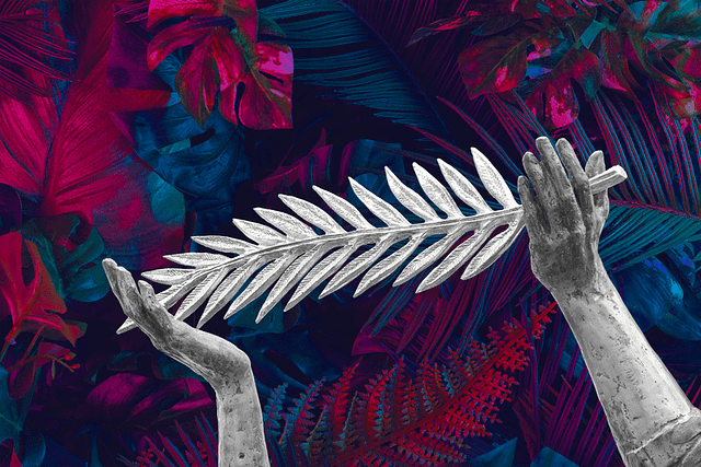 A stone Palme D'Or held in two hands against a backdrop of blue and magenta foliage
