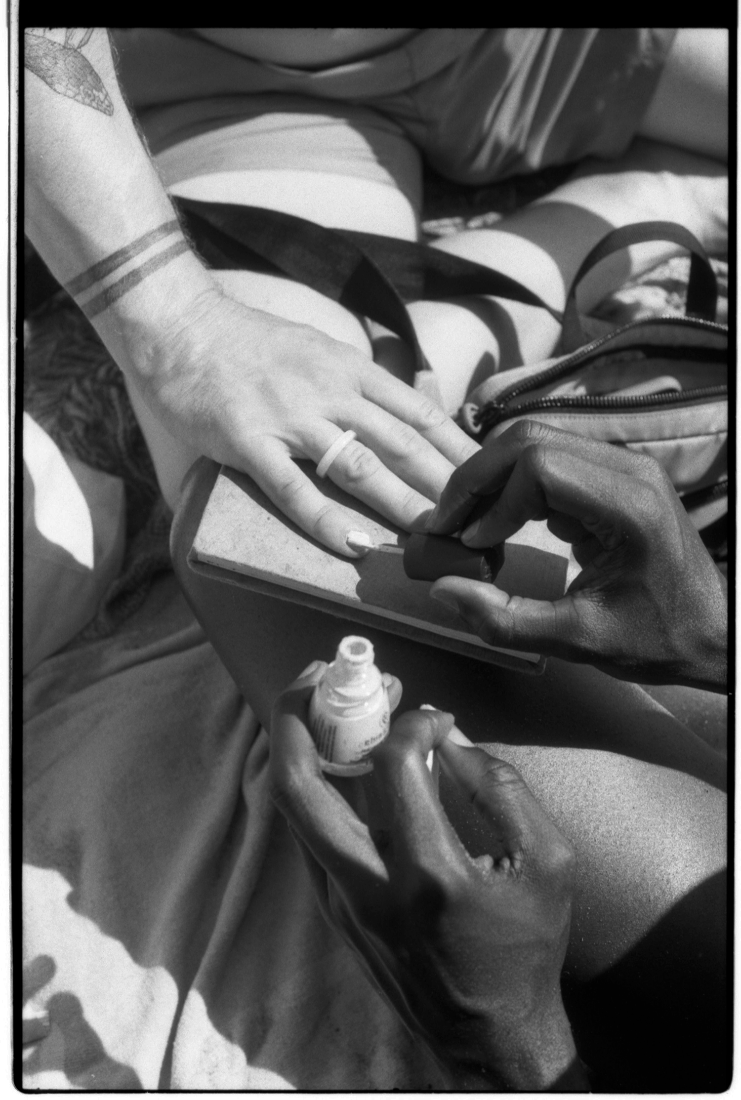 Friends paint each other‘s nails at Riis Beach.