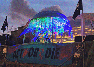 Photo of the rave float at dusk. A large banner with the words 