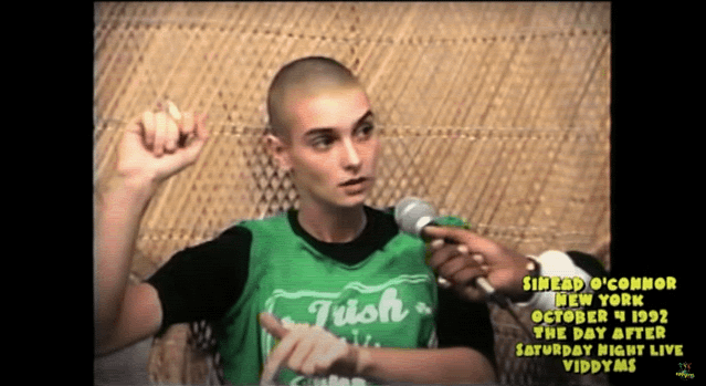 Sinead O'Connor in a 1992 interview following her infamous SNL performance, holding up a fist