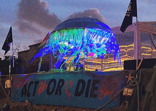 Photo of the rave float at dusk. A large banner with the words 